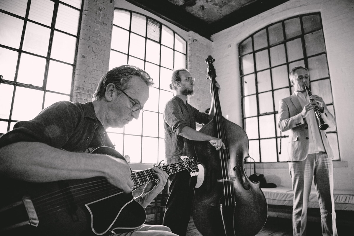 Dave Kelbie filming with The Dime Notes black and white