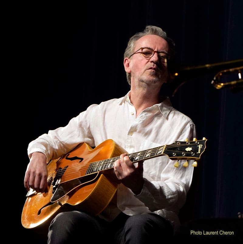 Dave Kelbie on stage playing guitar with The Viper Club