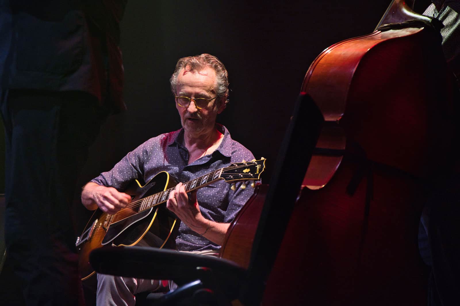 Dave Kelbie on stage playing guitar